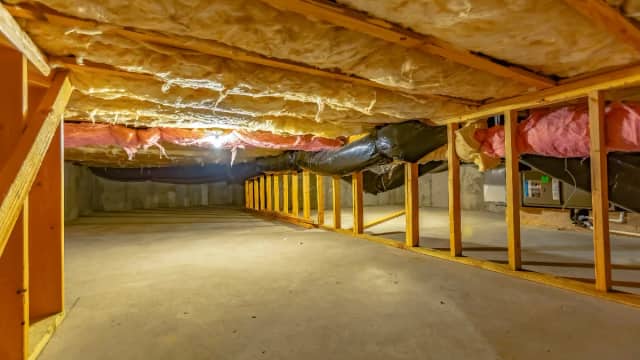 Crawl space with floor-joist insulation and ductwork