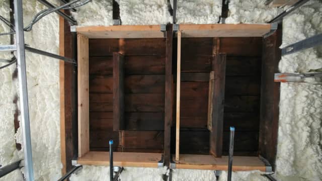 Spray foam insulation applied between wood wall studs