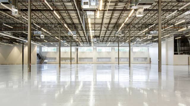 Empty industrial warehouse interior with high bay ceiling